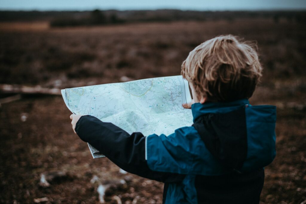 child looking at map outdoors