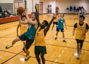 group of school kids playing basketball