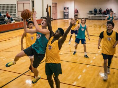 group of school kids playing basketball