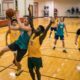 group of school kids playing basketball