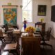 vacant white painted classroom with chairs, tables , and map on the wall