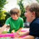 boy in blue shirt screaming near boy in green crew-neck shirt