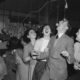 a black and white photo of a group of people dancing