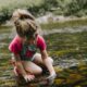 girl playing on body of water