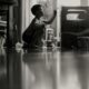 young boy sitting on floor at home painting something