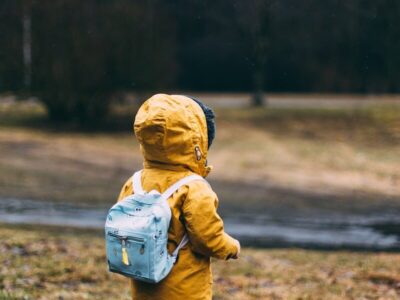 shallow focus photo of toddler walking near river
