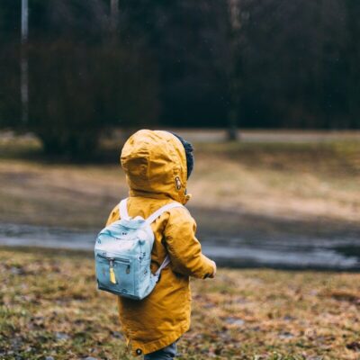 shallow focus photo of toddler walking near river