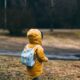 shallow focus photo of toddler walking near river