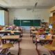 A classroom filled with lots of desks and chairs